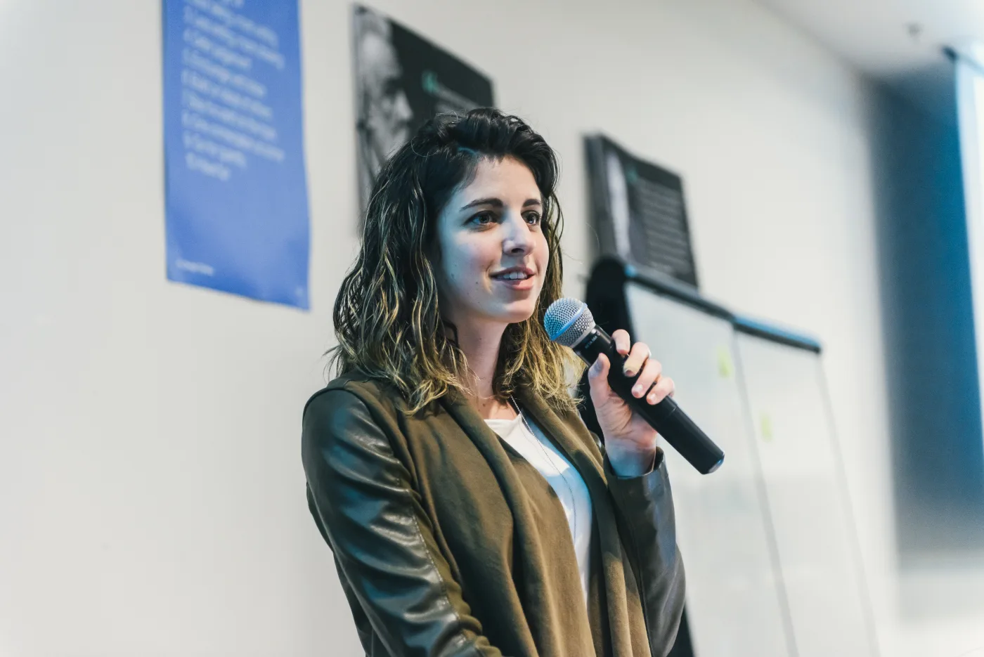 A HumanSide facilitator leading a live session with a microphone.